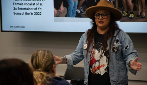 A woman speaking in front of others.
