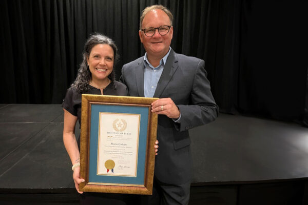 The Cohans hold a framed award