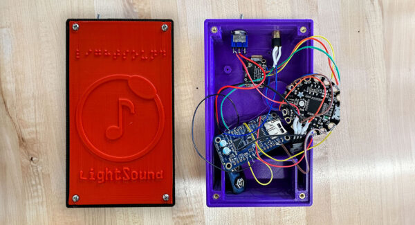 Two LightSound devices: One finished and another showing the inner wiring and circuit boards