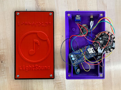 Two LightSound devices: One finished and another showing the inner wiring and circuit boards