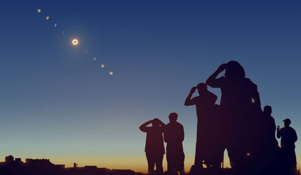 Group of people look up at sky to view eclipse.