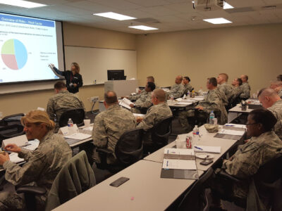 Natalie Sjelin gives a presentation to a classroom of National Guard members